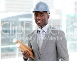 Portrait of a charismatic male architect holding blueprints