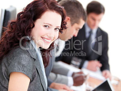Confident buinesswoman smiling at the camera in a meeting