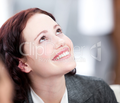 Radiant young buinesswoman smiling in a meeting
