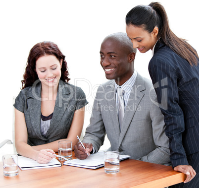 Confident business co-workers studying a document