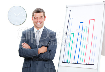 Cheerful businessman with folded arms doing a presentation