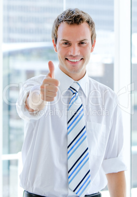 Portrait of a charismatic businessman with a thumb up