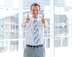 Portrait of a successful businessman with thumbs up