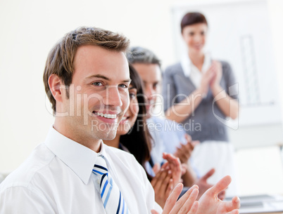 Smling business people applauding a good presentation