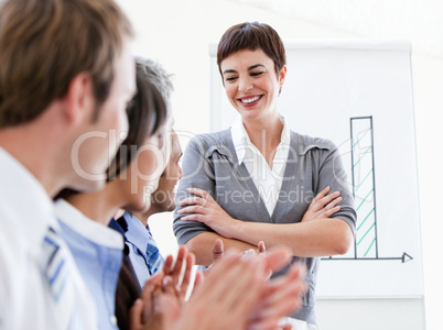 Happy business people applauding a good presentation