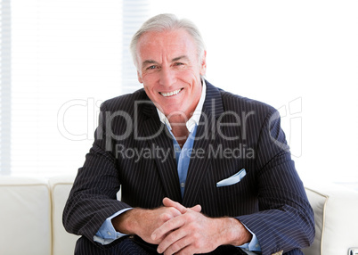 Happy senior businessman sitting on a sofa