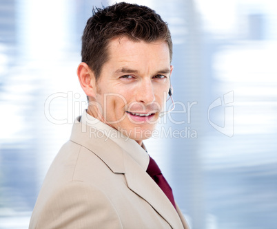 Confident businessman with headset on standing