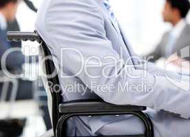 Close-up of a businessman sitting on a wheelchair