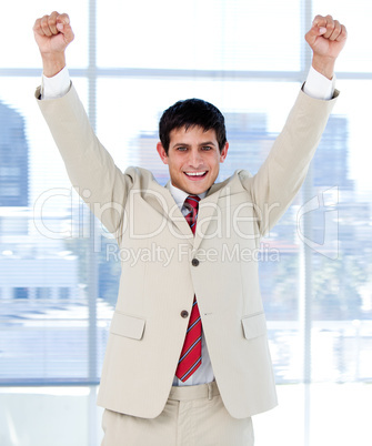 Cheerful businessman punching the air in celebration