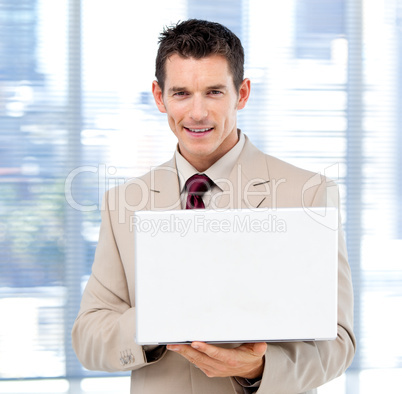 Handsome businessman using a laptop standing