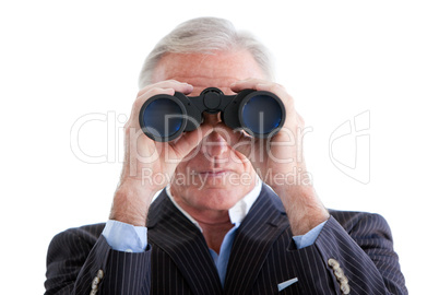 Serious businessman looking through binoculars standing