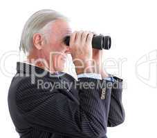 Senior businessman looking through binoculars standing