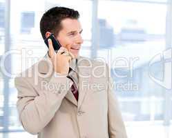 Charming businessman talking on phone standing
