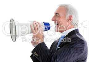 Senior smiling businessman using a megaphone