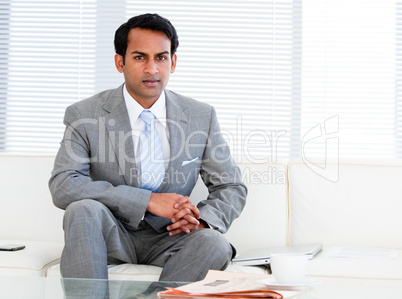 Self-assured businessman sitting on the sofa