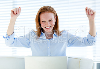 Bright business woman punching the air