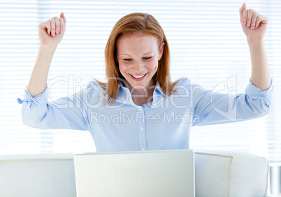 Radiant business woman punching the air