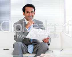 Smiling businessman holding a note