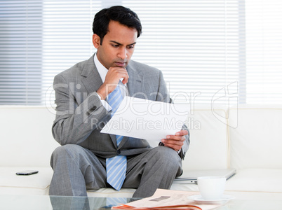 Confident businessman reading a note