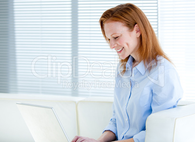 Happy business woman working on a laptop computer