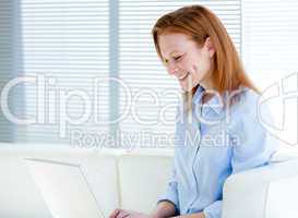 Happy business woman working on a laptop computer