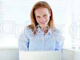 Self-assured business woman working on a laptop computer