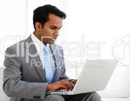 Self-assured businessman working on his computer