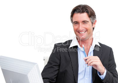 Cheerful businessman working at a computer