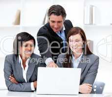 Multi-ethnic business team working at a computer