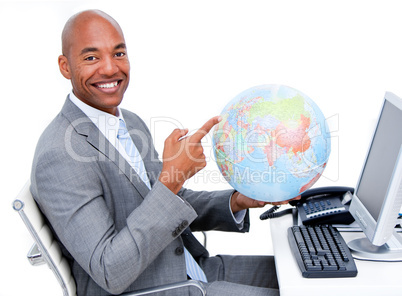 Smiling businessman holding a terrestrial globe