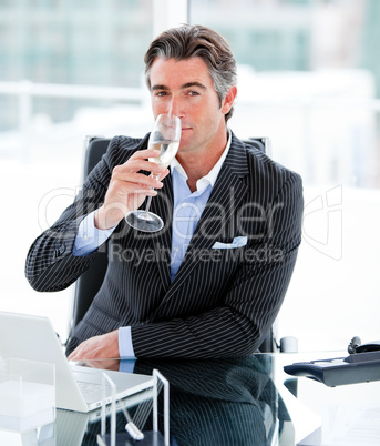Confident businessman drinking a glass of water