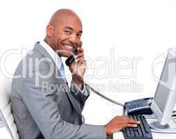 Smiling Afro-American businessman talking on phone