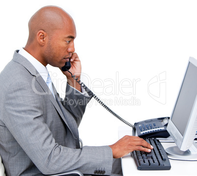 Serious Afro-American businessman talking on phone