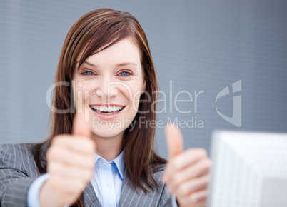 Jolly businesswoman with thumbs up