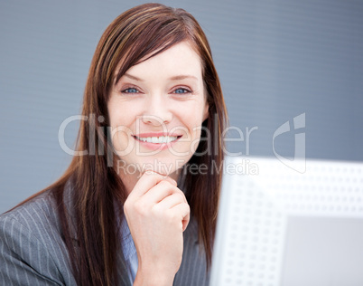 Cheerful businesswoman working at a computer