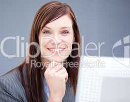 Cheerful businesswoman working at a computer