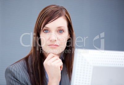 Confident businesswoman working at a computer