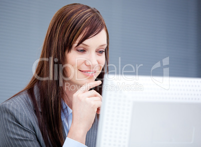 Radiant businesswoman working at a computer