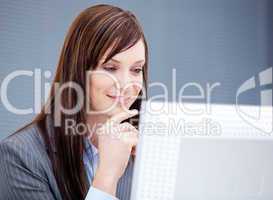 Radiant businesswoman working at a computer