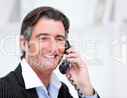 Handsome mature businessman talking on phone