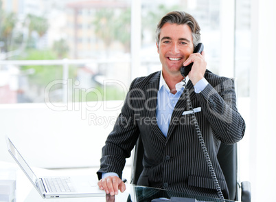 Confident mature businessman talking on phone