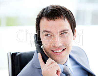 Assertive young businessman talking on phone