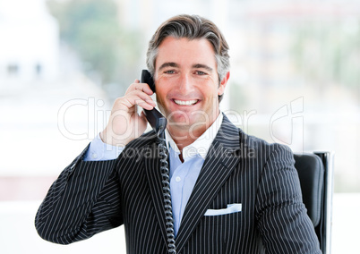 Self-assured mature businessman talking on phone