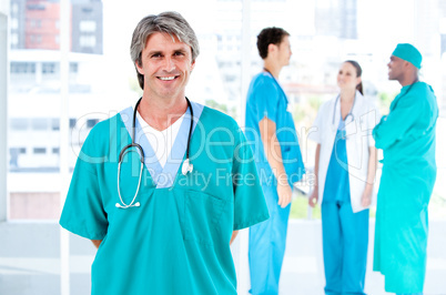 Joyful male doctor looking at the camera while his medical partn