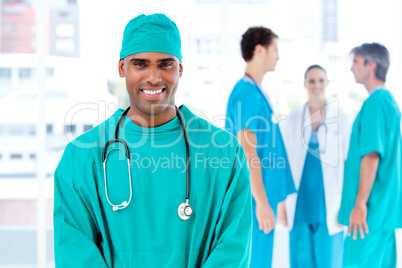 Afro male doctor looking at the camera while his medical partner