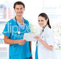 Smiling partners holding a patient diagnosis