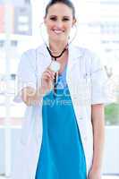 Caucasian female doctor holding a stethoscope