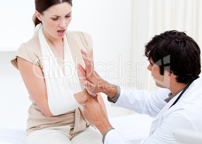Professional male doctor examining the female patient by taking