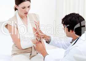 Professional male doctor examining the female patient by taking