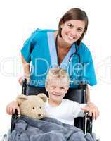 Nice female doctor carrying adorable little boy in the wheelchai